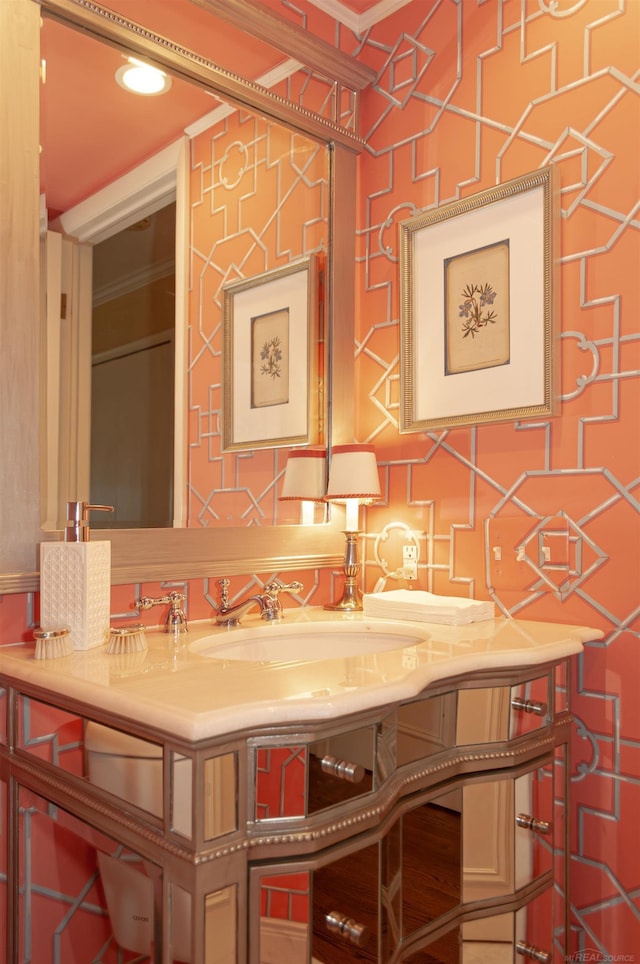 bathroom featuring vanity and ornamental molding