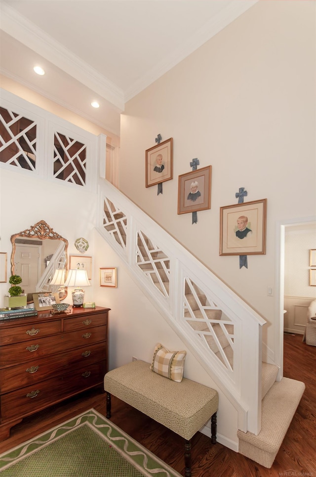 staircase featuring crown molding, recessed lighting, and wood finished floors