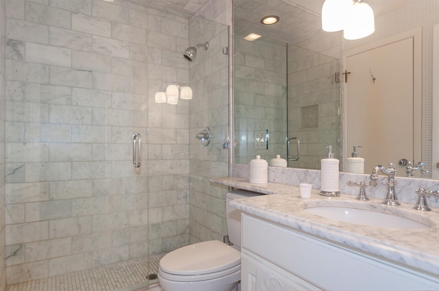 bathroom featuring vanity, toilet, and a shower stall