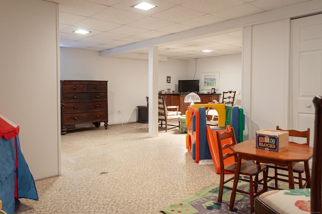 game room featuring tile patterned floors and a drop ceiling