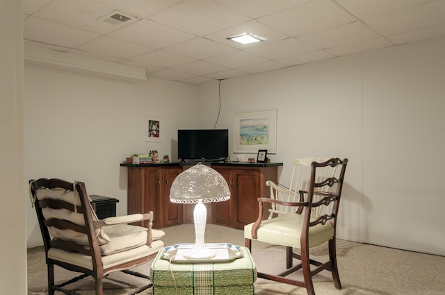 living area featuring visible vents and a paneled ceiling