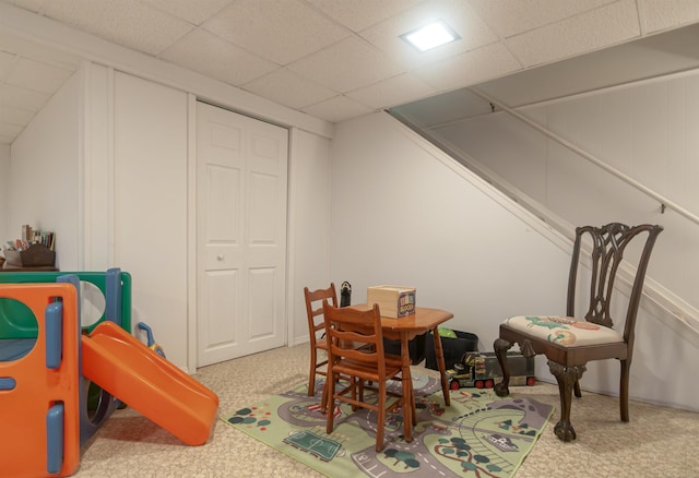 rec room featuring carpet flooring and a paneled ceiling