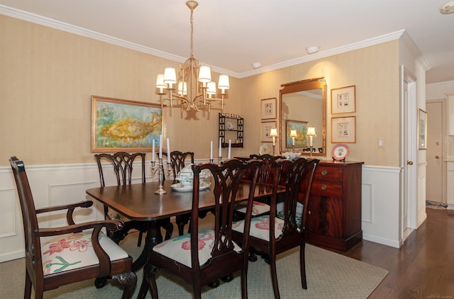 dining area featuring a chandelier, wood finished floors, wainscoting, and crown molding