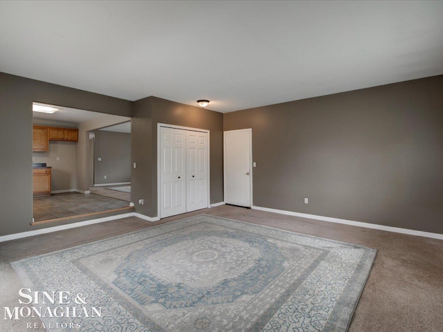 interior space with light colored carpet and baseboards