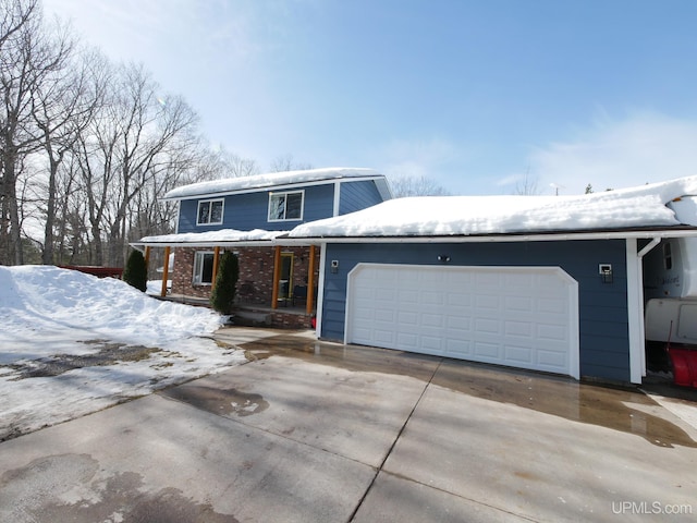 traditional-style house with an attached garage, brick siding, and driveway