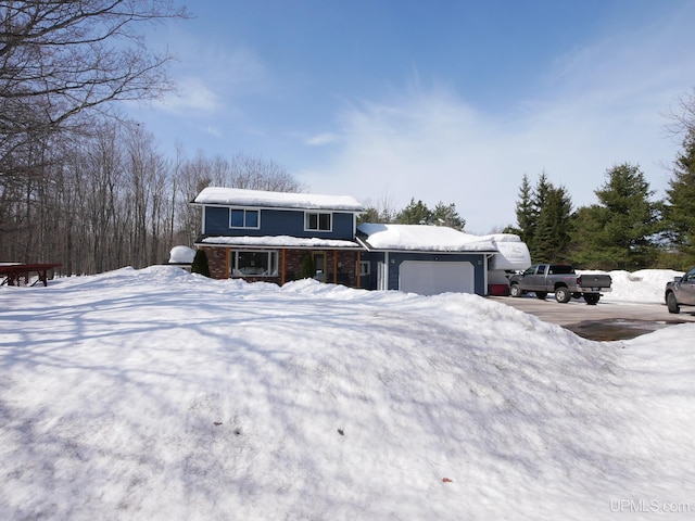 view of front facade featuring an attached garage and brick siding