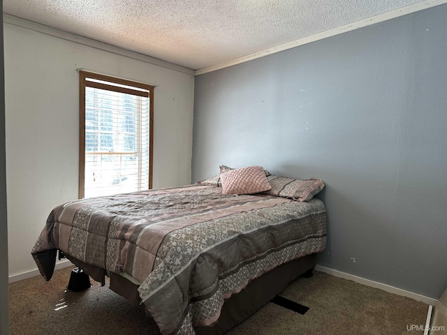 bedroom featuring baseboards, carpet floors, and a textured ceiling