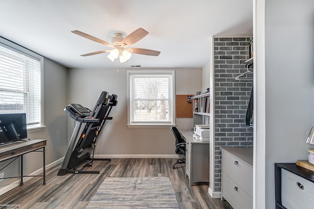 office space with visible vents, baseboards, ceiling fan, and dark wood-style flooring