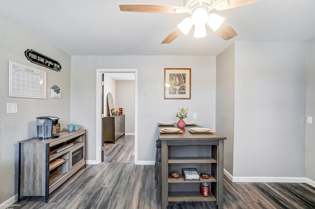 hallway with baseboards and wood finished floors