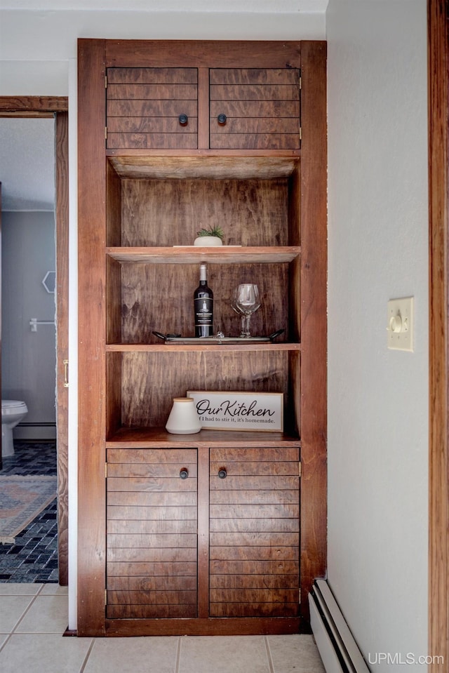 interior details with built in shelves and a baseboard heating unit