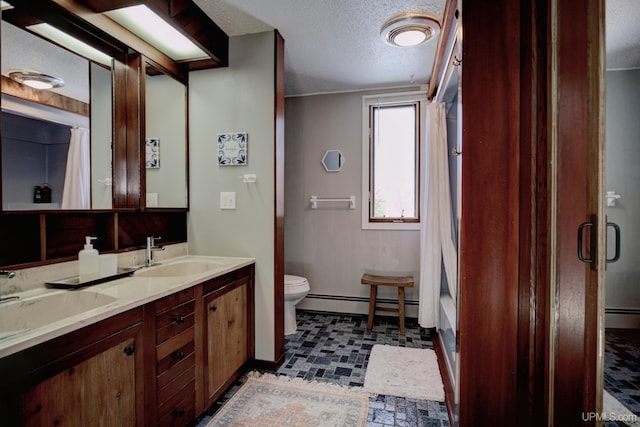 bathroom featuring a sink, a baseboard heating unit, a textured ceiling, and a shower with shower curtain