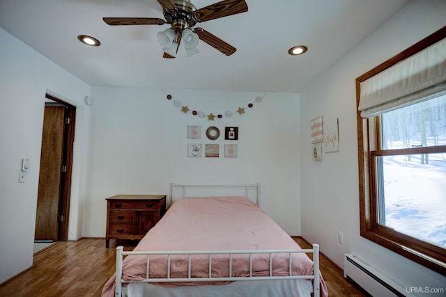 bedroom featuring recessed lighting, wood finished floors, ceiling fan, and a baseboard radiator