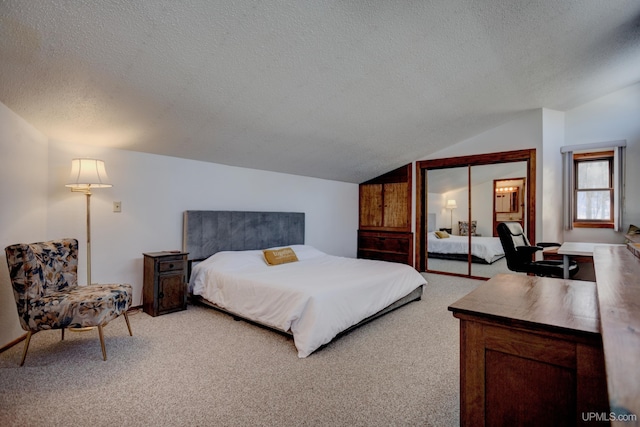 bedroom with a textured ceiling, lofted ceiling, and light carpet