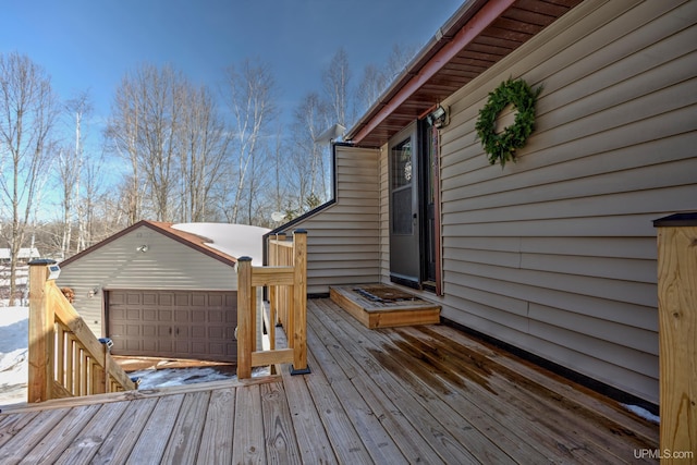 deck featuring a garage and an outbuilding