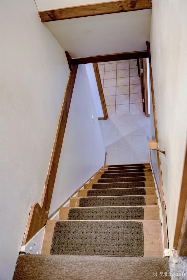 staircase featuring tile patterned flooring