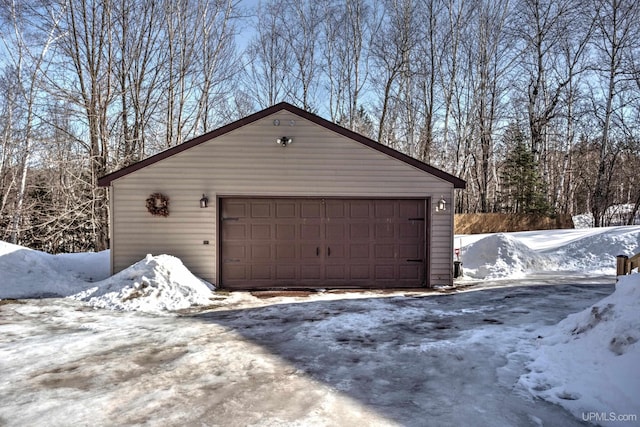 snow covered garage with a garage