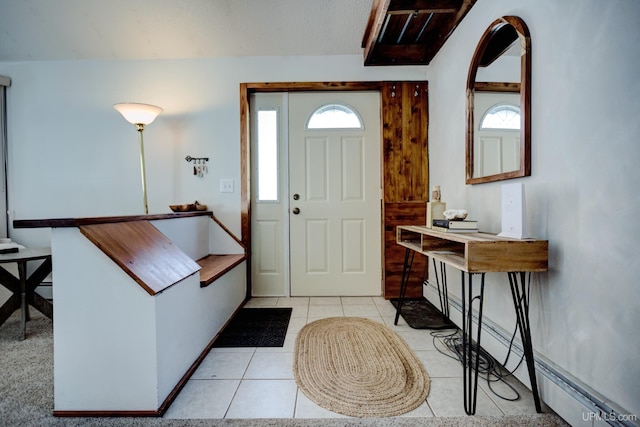 entryway featuring light tile patterned floors, a baseboard radiator, and baseboards