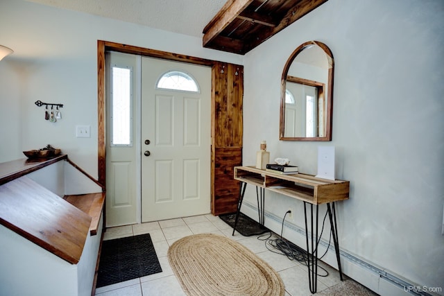 foyer with light tile patterned floors, a textured ceiling, and a baseboard heating unit