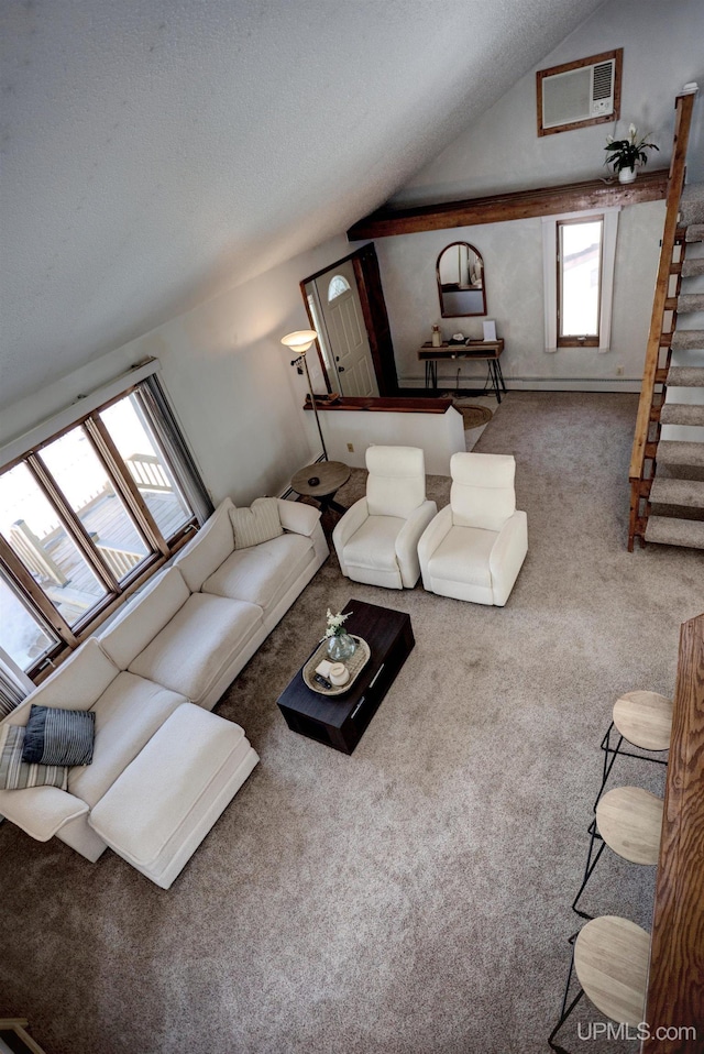 carpeted living area with stairway, lofted ceiling, a textured ceiling, and an AC wall unit