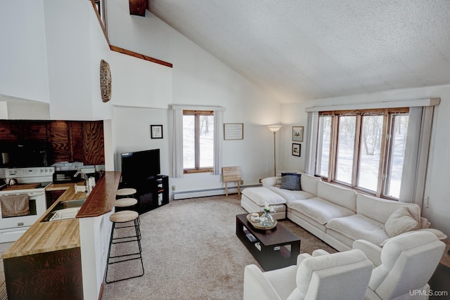 carpeted living area with a sink, a baseboard heating unit, a textured ceiling, and high vaulted ceiling