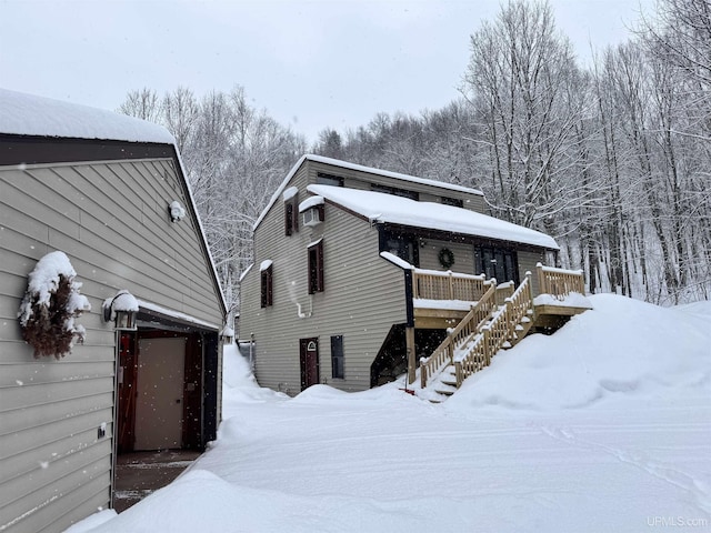 exterior space with a garage, stairs, and a deck