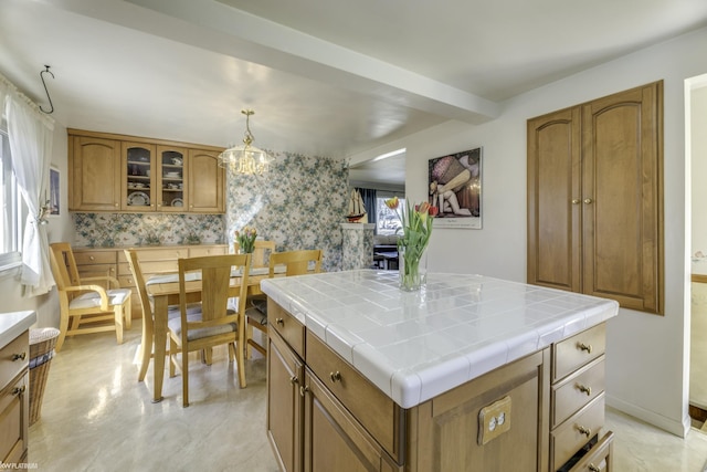 kitchen featuring tile countertops, glass insert cabinets, and brown cabinets