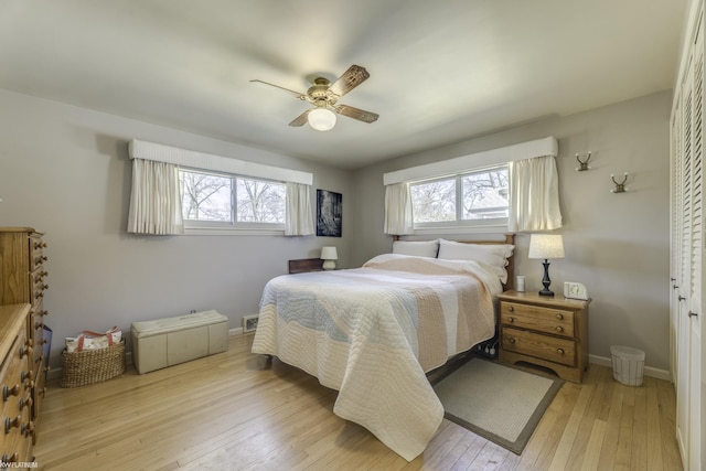 bedroom featuring light wood finished floors, ceiling fan, and baseboards