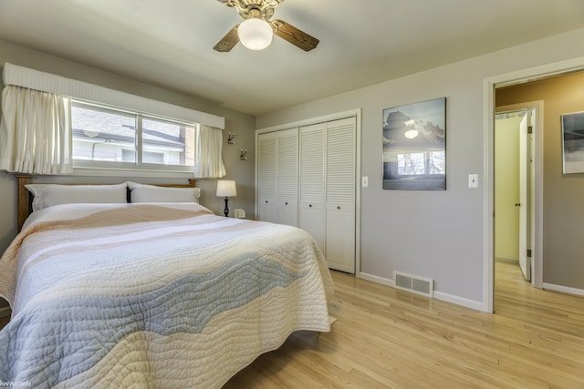 bedroom featuring visible vents, baseboards, light wood-style floors, and a closet