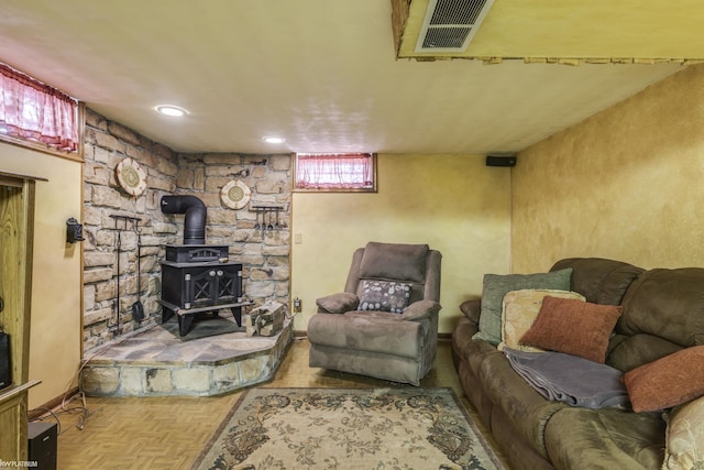 living room with visible vents and a wood stove