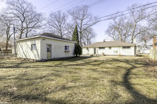 view of yard featuring an outdoor structure and fence