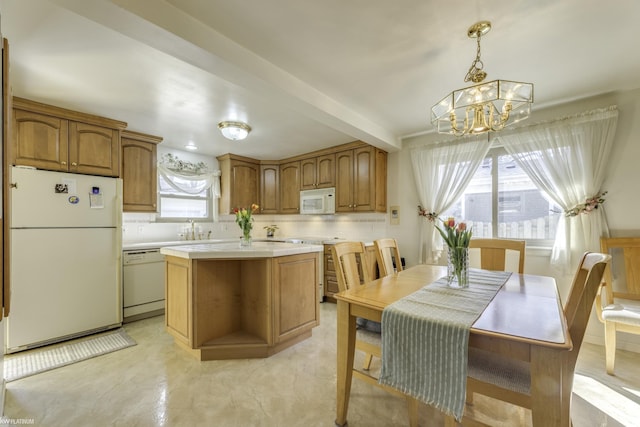 kitchen featuring a sink, a center island, white appliances, brown cabinetry, and light countertops