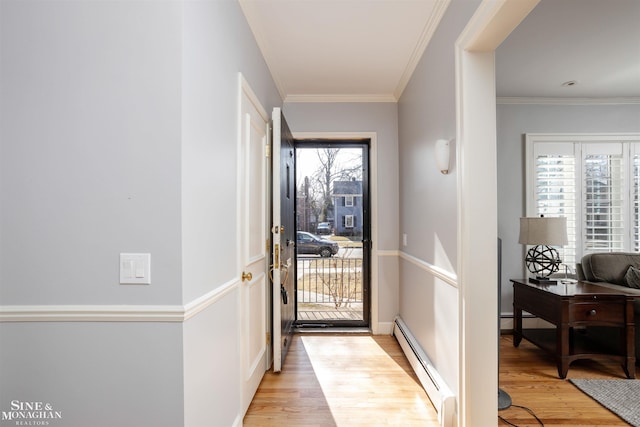 doorway to outside featuring crown molding, light wood-style floors, baseboards, and a baseboard radiator