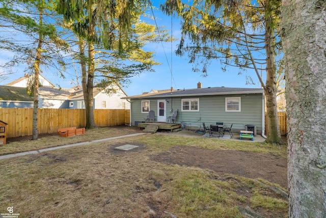 back of property featuring a patio area, a fenced backyard, a lawn, and central AC