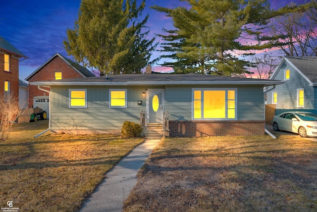 view of front facade featuring a front lawn and brick siding