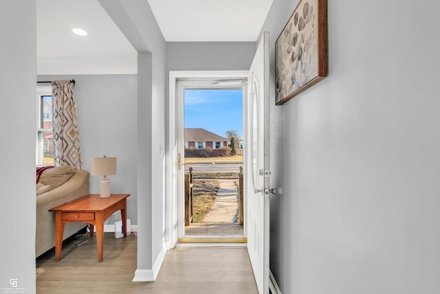 entrance foyer with light wood-style floors and baseboards