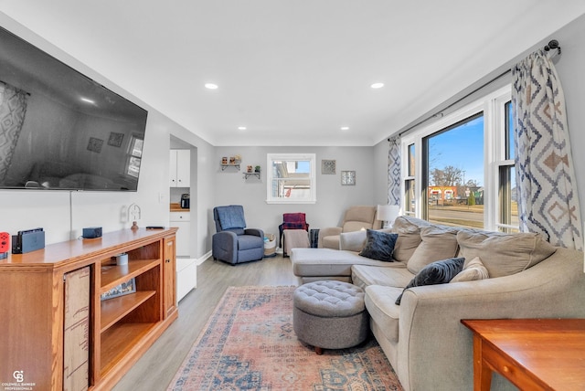 living area with recessed lighting, baseboards, and light wood-style floors