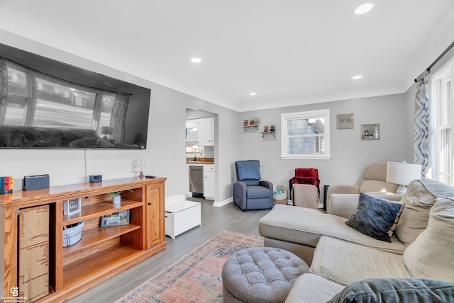 living area featuring recessed lighting, wood finished floors, and baseboards