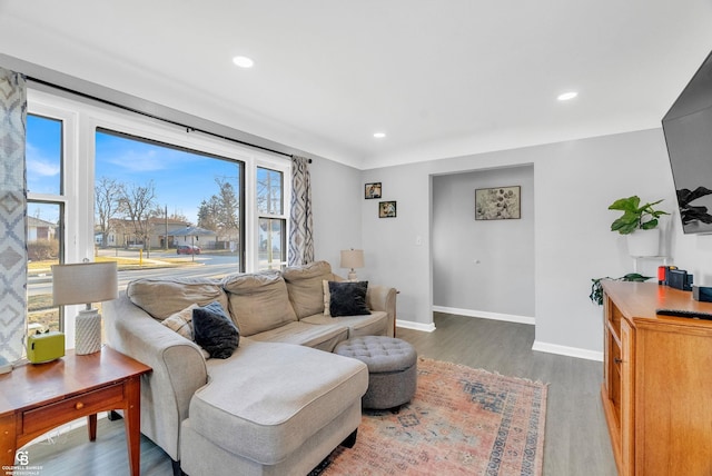 living room with recessed lighting, baseboards, and wood finished floors