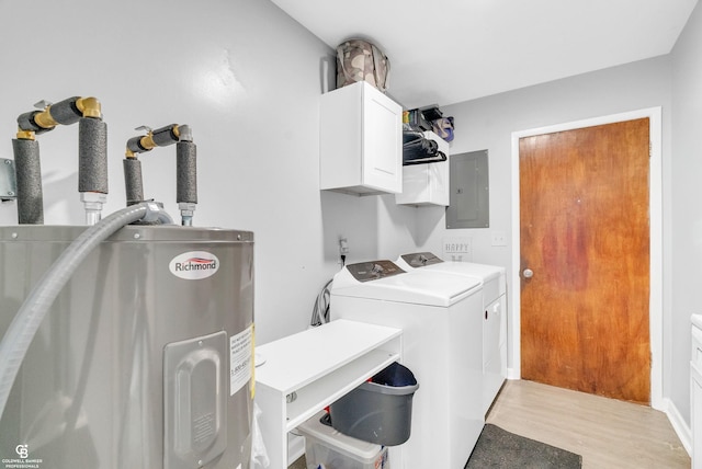 washroom with electric water heater, electric panel, light wood-style flooring, cabinet space, and separate washer and dryer