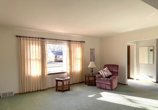 living area featuring visible vents, carpet floors, and baseboards