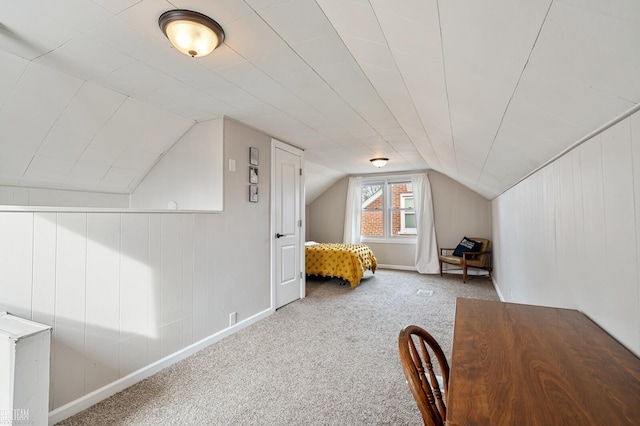 unfurnished bedroom featuring lofted ceiling and carpet flooring