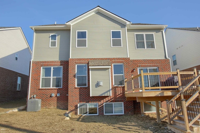 back of house with stairway, brick siding, central AC, and a wooden deck