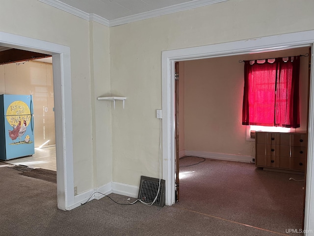 hallway featuring ornamental molding, baseboards, and carpet floors