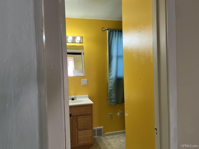 bathroom with visible vents, vanity, and baseboards