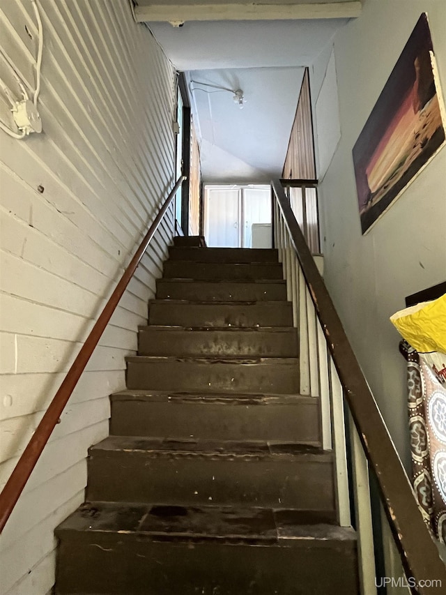 staircase with a towering ceiling