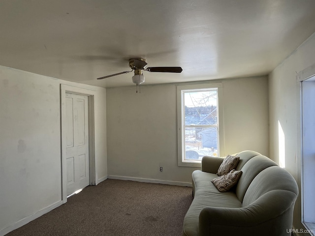 sitting room featuring carpet flooring, baseboards, and ceiling fan