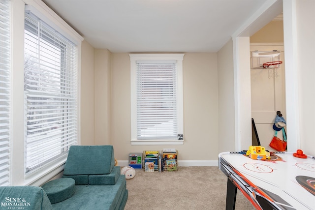 recreation room with plenty of natural light, carpet, and baseboards