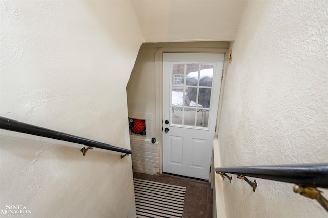 staircase with a textured wall