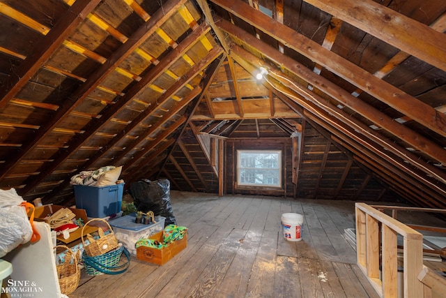 unfinished attic featuring an upstairs landing