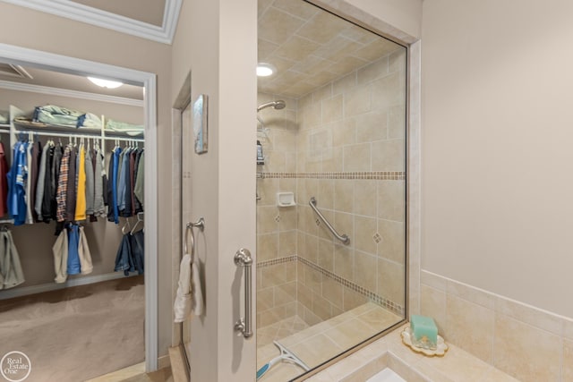 bathroom featuring a walk in closet, ornamental molding, and a shower stall